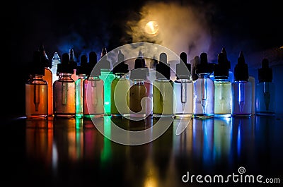 Vape concept. Smoke clouds and vape liquid bottles on dark background. Light effects. Useful as background or vape advertisement o Stock Photo