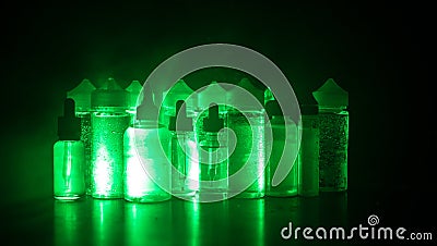 Vape concept. Smoke clouds and vape liquid bottles on dark background. Light effects Stock Photo