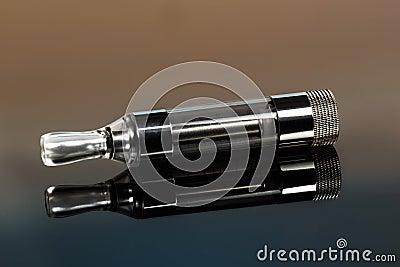Vape, electronic cigarette exploded next to a conventional cigarette on a dark background Stock Photo