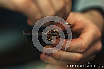 Vape after-sales service of the electronic cigarette. Male hands regulate e-cig coils. Stock Photo