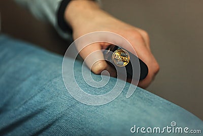 Vape after-sales service of the electronic cigarette. Male hands regulate e-cig coils. Stock Photo