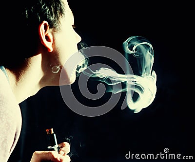 Vape trick jellyfish in performance of vaper on dark background at overexposure Stock Photo