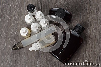 Vaping e-cigarette liquid on wooden background Stock Photo