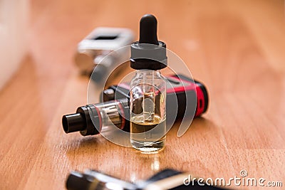 Vaping electronic mod and vape liquid. Stock Photo