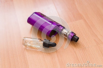 Vaping electronic mod and vape liquid. Stock Photo