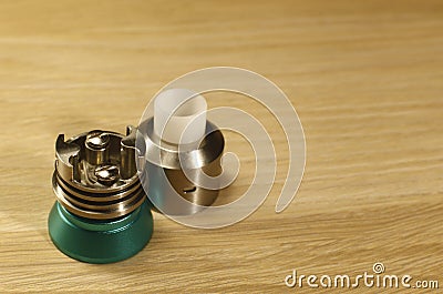 Vaping rebuildable dripping atomizer RDA on wooden surface with copy space close up Stock Photo