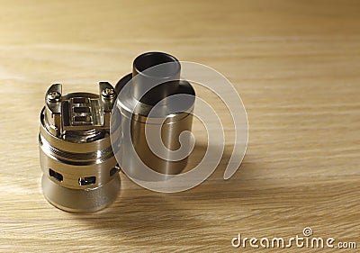 Vaping rebuildable dripping atomizer RDA on wooden surface with copy space close up Stock Photo