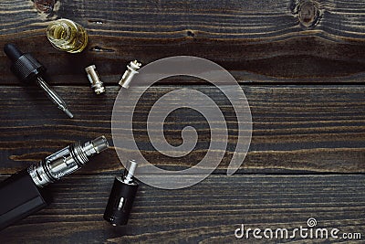 Vaping set with copy space on the wooden background. Stock Photo