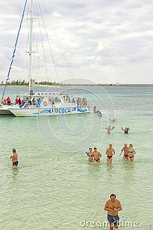 VARADERO, CUBA - JANUARY 06, 2018: People in cold water leave the damaged ship Editorial Stock Photo