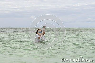 VARADERO, CUBA - JANUARY 06, 2018: A woman in cold water leaves Editorial Stock Photo