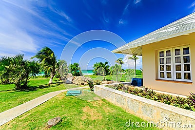 inviting beautiful natural landscape view of villa house in tropical garden right near the beach and tranquil turquoise tender oc Editorial Stock Photo