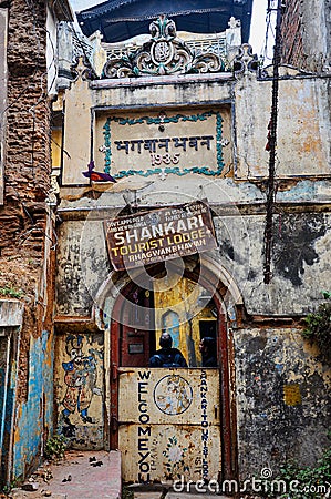 Varanasi, India - Dec 24, 2019: View of an old hostel in a traditional narrow street in the old city of Varanasi, India Editorial Stock Photo