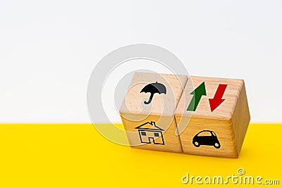 Variable insurance costs, increasing and decreasing, concept, wooden cubes with up and down arrow symbols, market analysis. Stock Photo