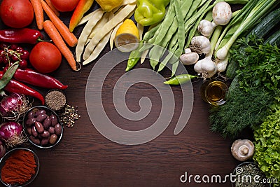 Variation of autumn vegetables and spices with dark wooden background Stock Photo
