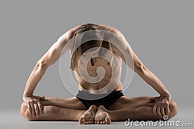 Variation of bound angle yoga pose Stock Photo