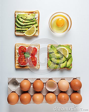 Variation of healthy breakfast toasts with avocado and cherry tomatoes on white background. Stock Photo