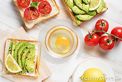 Variation of healthy breakfast toasts with avocado and cherry tomatoes Stock Photo