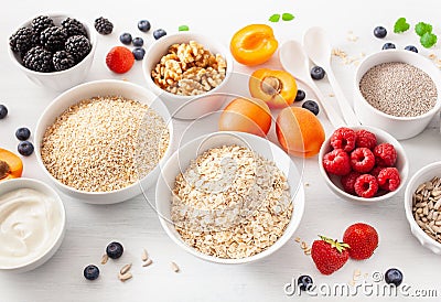 Variaty of raw cereals, fruits and nuts for breakfast. Oatmeal f Stock Photo
