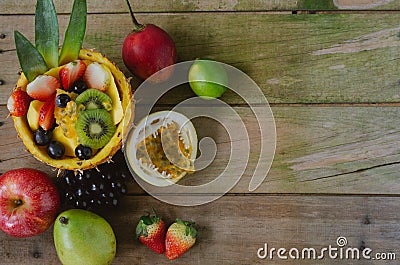 Varied fruits on rustic wooden background. Flat lay Stock Photo