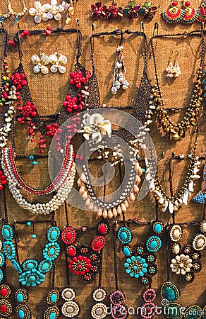 Variety of Beautiful Creative Shine Colorful Stone Plastic Jewellery Necklaces Hanging on The Wall for Sale in The Market Stock Photo