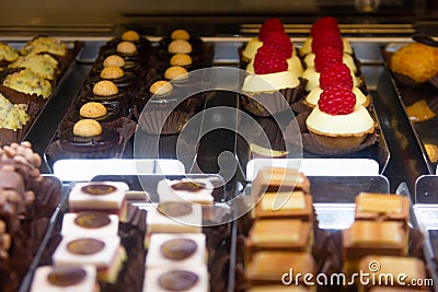 Variety of bite cakes with raspberry, chocolate and cookies Stock Photo