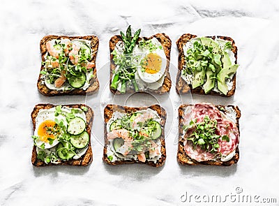 Variety breakfast, appetizer, tapas whole grain bread sandwiches with cream cheese, egg, asparagus, avocado, cucumber, shrimp, Stock Photo