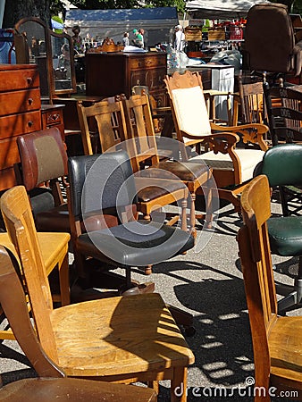 A variety of chairs lined up at an outdoor flea market. Editorial Stock Photo