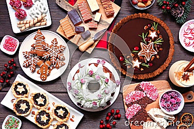 Variety of Christmas holiday desserts and sweets. Above view table scene over a wood background. Stock Photo