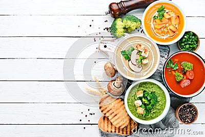 Variety of colorful vegetables cream soups. Concept of healthy eating or vegetarian food. Top view. Stock Photo