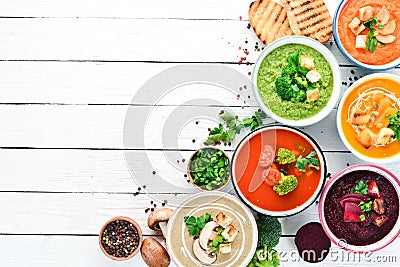 Variety of colorful vegetables cream soups. Concept of healthy eating or vegetarian food. Top view. Stock Photo