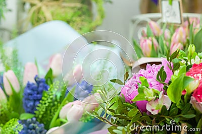 A variety of flowers in the window of a flower shop. Showcase. Stylish bouquets. Small business. Behind the glass. Selective focus Stock Photo