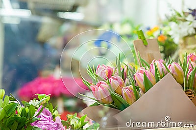 A variety of flowers in the window of a flower shop. Showcase. Stylish bouquets. Small business. Behind the glass. Selective focus Stock Photo