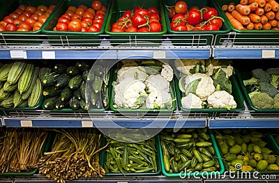 Variety of fresh vegetables on display in grocery store Stock Photo