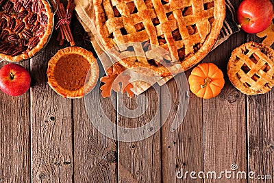 Variety of homemade autumn pies. Top border over a rustic wood background. Stock Photo