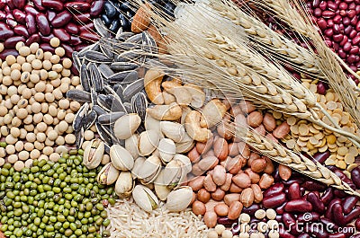 Variety kind of dry organic cereal and grain seeds pile with bundle of dry wheat in dark tone Stock Photo