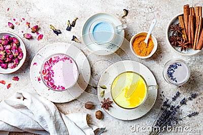 Variety of Moon Milk for a better sleep. Turmeric golden milk, pink rose milk, blue butterfly pea and lavender moon milk. Stock Photo