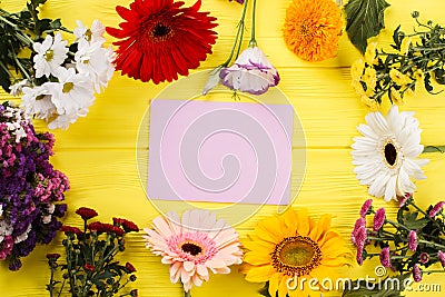 Variety of multicolored blossoming flowers and blank paper. Stock Photo