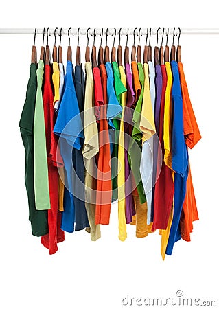 Variety of multicolored shirts on wooden hangers Stock Photo