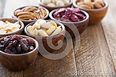 Variety of nuts and dried fruits in small bowls Stock Photo