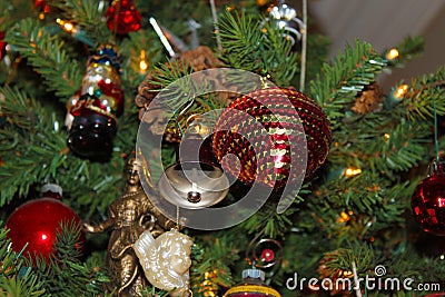 A variety of old fashioned ornaments and pine cones on a Christmas Tree Stock Photo