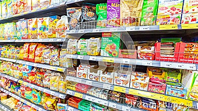 A variety of packaged products on the shelf in the supermarket. Editorial Stock Photo