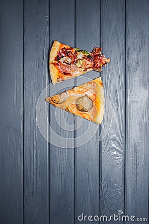 A variety of pizzas lie on a wooden table. view from above. Stock Photo
