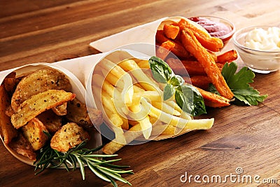 Variety of potatoes with fries. potato wedges, french fries, sweet potato for lunch on table Stock Photo