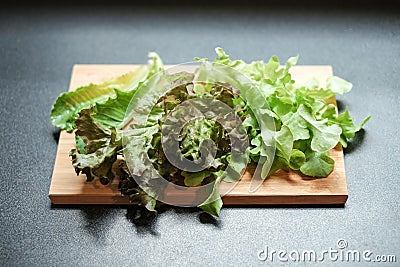 Variety of raw green vegetables salads with chopping board Stock Photo