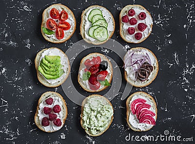 Variety of sandwiches - sandwiches with cheese, tomatoes, anchovies, roasted peppers, raspberries, avocado, bean pate, cucumber Stock Photo