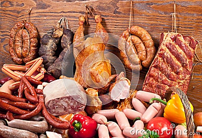 Variety of sausage products and vegetables. Stock Photo