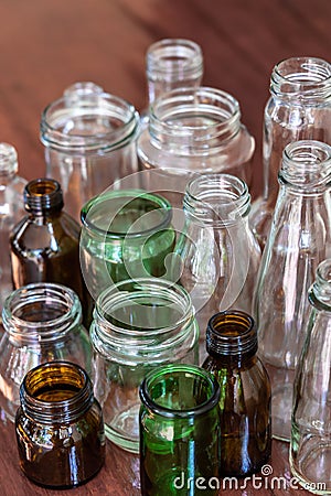 Variety shape and color of empty glass container bottles, reuse things concept Stock Photo