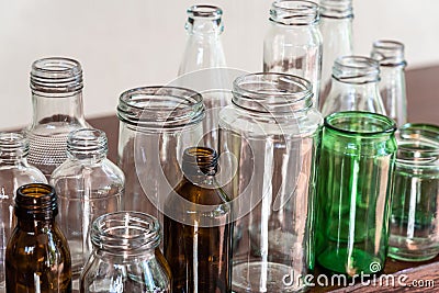 Variety shape and color of empty glass container bottles, reuse things concept Stock Photo