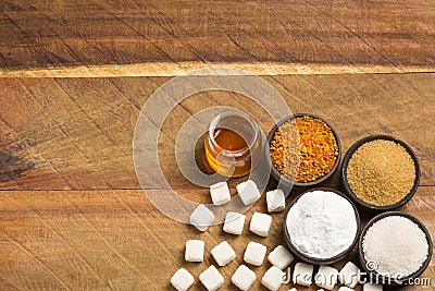 Variety of sweeteners - Stevia, sugar, pollen and honey. Wood background Stock Photo