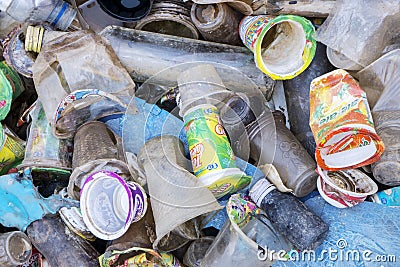 Variety waste of bottle glass and plastic on riverside Editorial Stock Photo